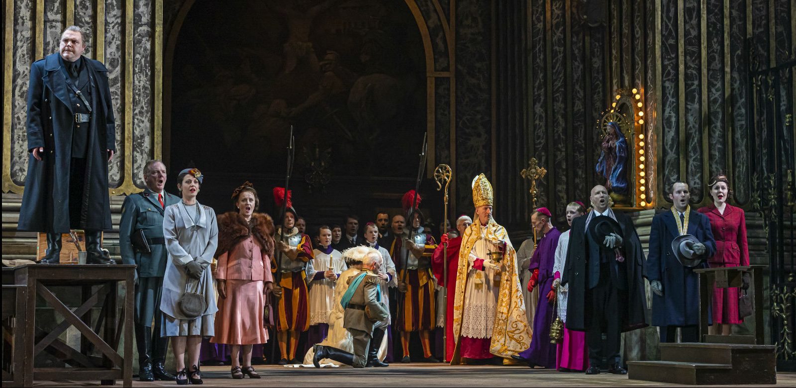 Roland Wood as Scarpia and the cast of Tosca